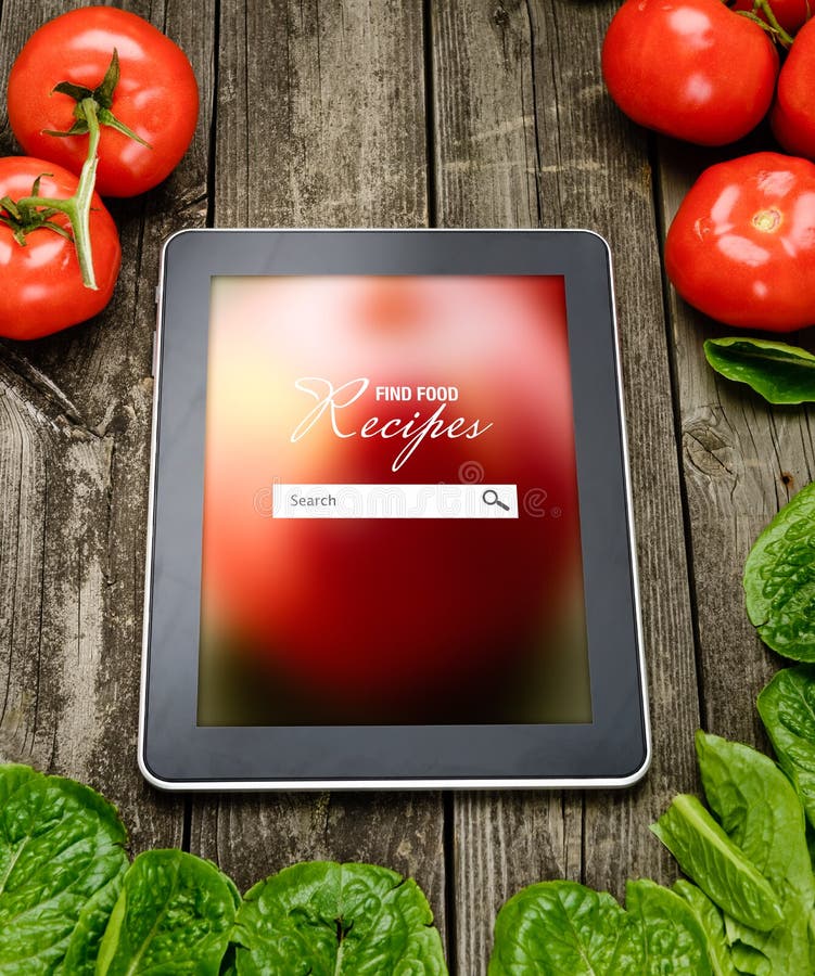 Online Cooking recipes on tablet pc with vegetables on backround. Online Cooking recipes on tablet pc with vegetables on backround.