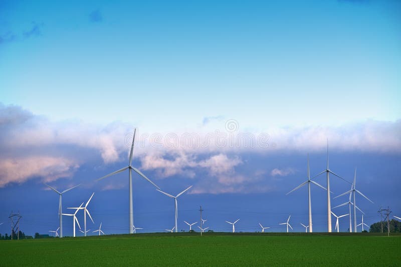 Alternative Energy Landscape - Wind Turbines Farm in Minnesotas Mower County near Dexter, MN. Wind Turbines in Sunset. Alternative Energy Landscape - Wind Turbines Farm in Minnesotas Mower County near Dexter, MN. Wind Turbines in Sunset