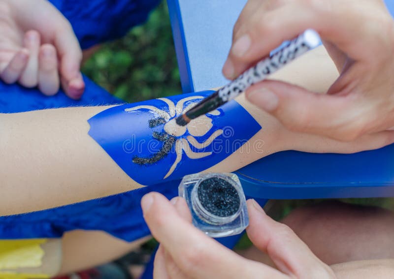 Het maken van de tatoegering van de kinderenspin stock foto's Het maken van de tatoegering van de kinderenspin stock foto's
