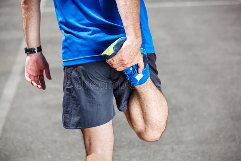 Male runner stretching before workout. Male runner stretching before workout.