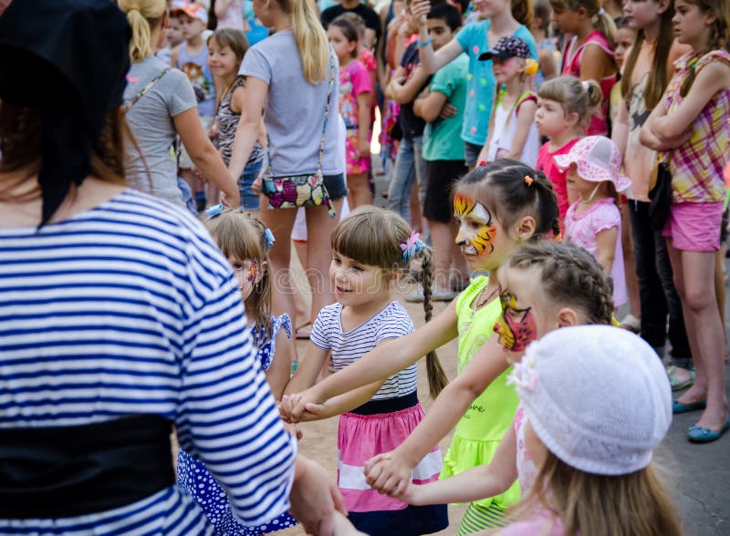 Het meisje kleedde zich in de loodroundelay van het piraatkostuum met groep kinderen stock foto Het meisje kleedde zich in de loodroundelay van het piraatkostuum met groep kinderen stock foto