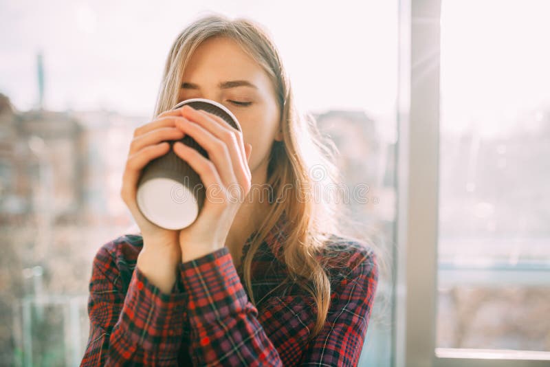 Het meisje loopt onderaan de straat met een document Kop van koffie, close-up, goed weer, vrouw in jasje, stock afbeeldingen Het meisje loopt onderaan de straat met een document Kop van koffie, close-up, goed weer, vrouw in jasje, stock afbeeldingen