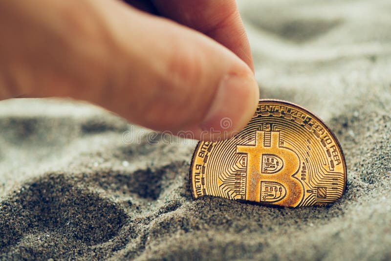 Het met de hand plukken van enige bitcoin van zand royalty-vrije stock foto's Het met de hand plukken van enige bitcoin van zand royalty-vrije stock foto's