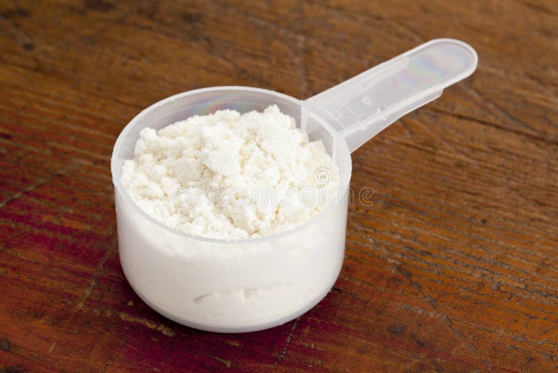 Maatlepel met wit poeder stock afbeeldingen