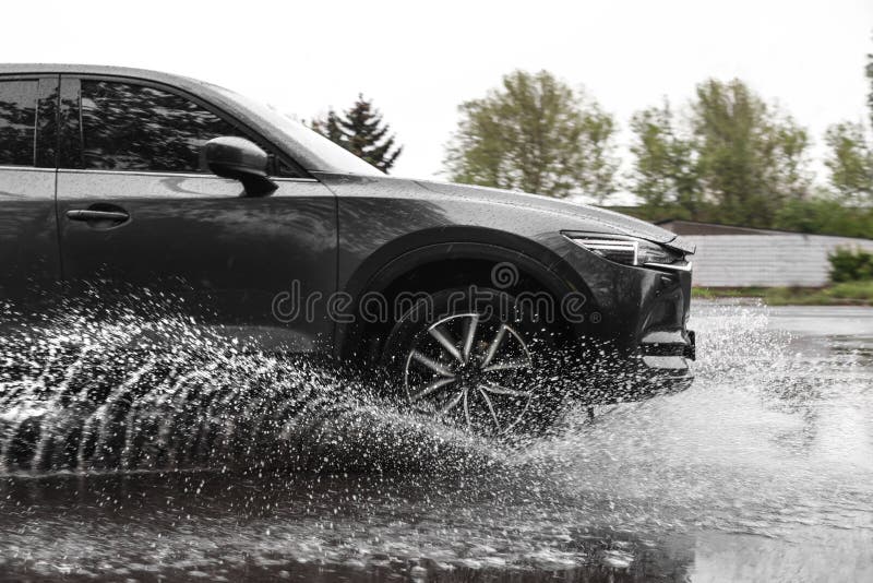 Modern car driving outdoors on rainy day. Modern car driving outdoors on rainy day