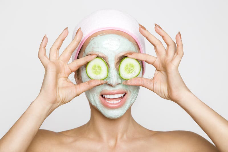 Beautiful blonde woman model with a facial mask, beauty spa and the eyes have green flakes. Beautiful blonde woman model with a facial mask, beauty spa and the eyes have green flakes