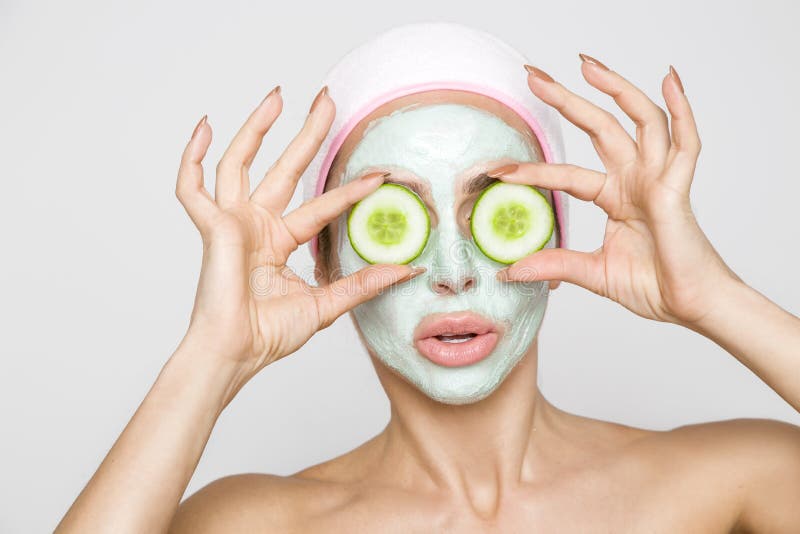 Beautiful blonde woman model with a facial mask, beauty spa and the eyes have green flakes. Beautiful blonde woman model with a facial mask, beauty spa and the eyes have green flakes