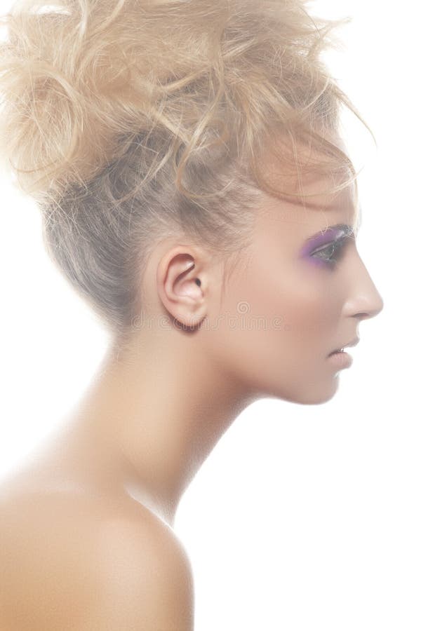 Fashion profile portrait of beautiful european young woman model with modern curly bun hairstyle, healthy skin and pastel violet eye make-up. Fashion profile portrait of beautiful european young woman model with modern curly bun hairstyle, healthy skin and pastel violet eye make-up