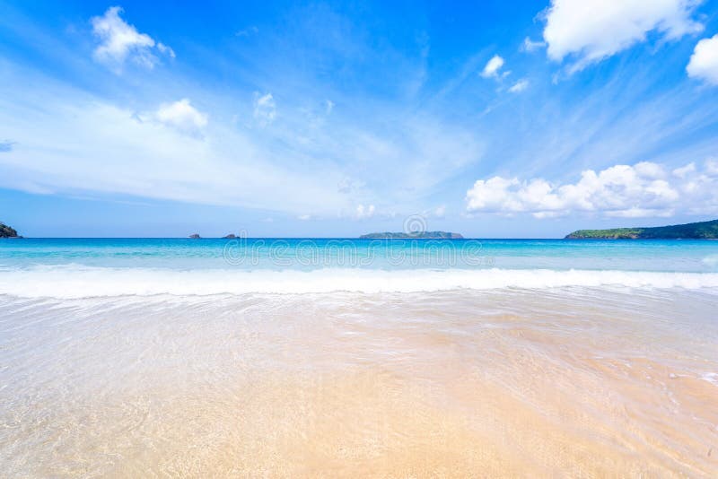 Beautiful amazing gold colored sandy beach with soft waves isolated with sunny blue sky. Concept of tropical calm tourism idea, copy space, close up. Beautiful amazing gold colored sandy beach with soft waves isolated with sunny blue sky. Concept of tropical calm tourism idea, copy space, close up