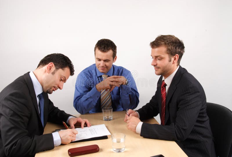 Businessmen negotiation and signing a contract. Businessmen negotiation and signing a contract.