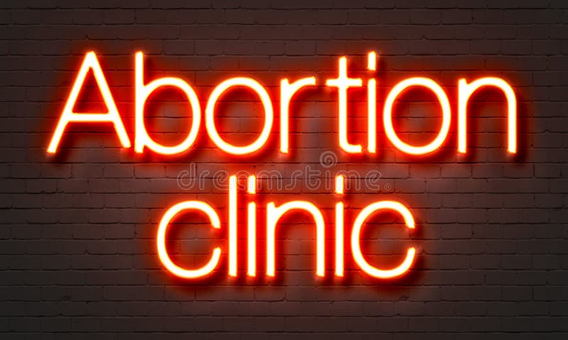 Het neonteken van de abortuskliniek op bakstenen muurachtergrond