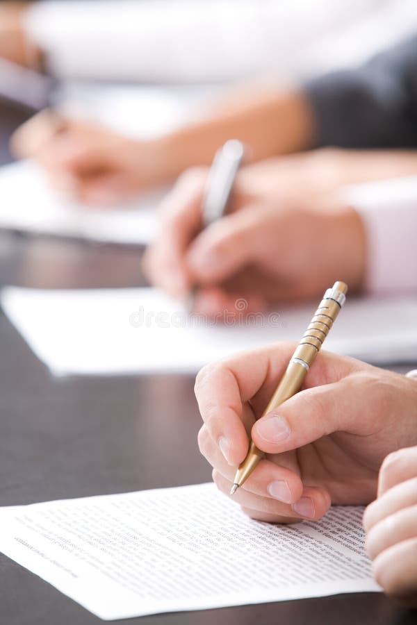 Close-up of human hands with pen over business document. Close-up of human hands with pen over business document