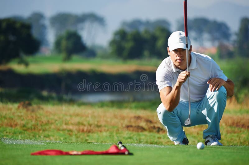 Golfer aiming lining up putt on green. Golfer aiming lining up putt on green