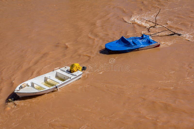 Couple of boats dragged by the water in a flood. Couple of boats dragged by the water in a flood.