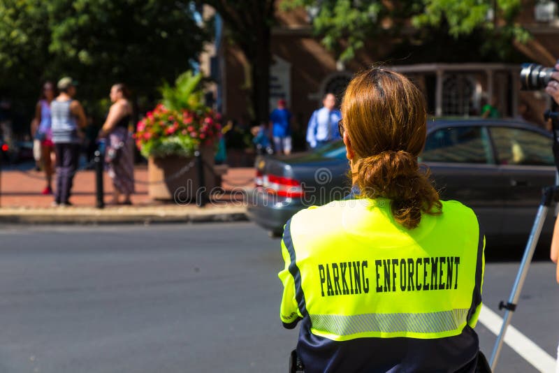 Lancaster, PA – August 4, 2016: A parking enforcement officer in the City of Lancaster. Lancaster, PA – August 4, 2016: A parking enforcement officer in the City of Lancaster.