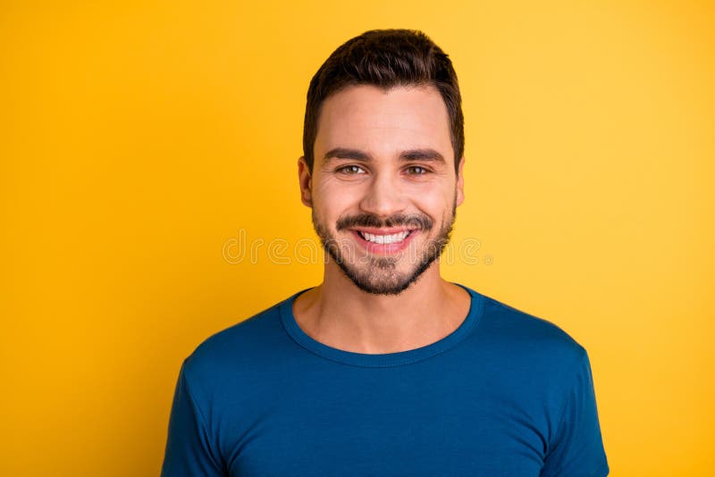 Close-up portrait of his he nice attractive cheerful cheery brunette guy wearing, blue tshirt isolated over bright vivid shine vibrant yellow color background. Close-up portrait of his he nice attractive cheerful cheery brunette guy wearing, blue tshirt isolated over bright vivid shine vibrant yellow color background