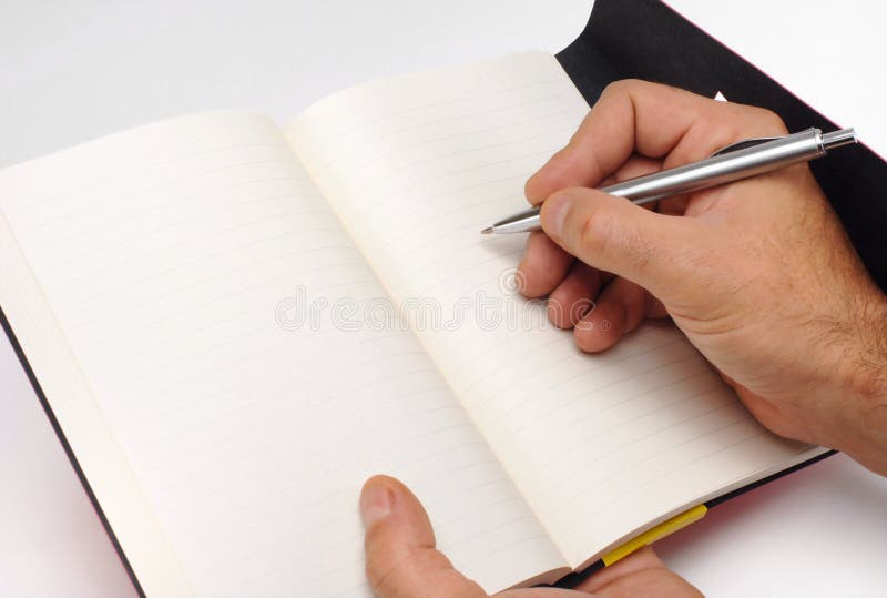 Hand die schrijft op een notitieboek royalty-vrije stock fotografie