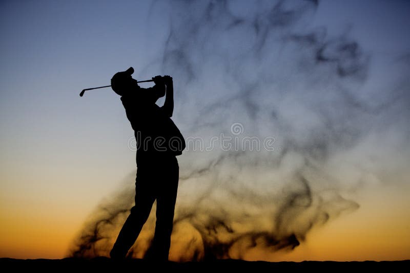 A golfer swinging in the sand during a beautiful sunset. A golfer swinging in the sand during a beautiful sunset