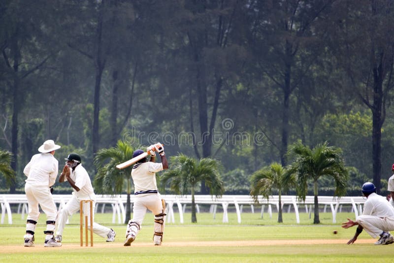 Players in action in an international friendly cricket game. Players in action in an international friendly cricket game.