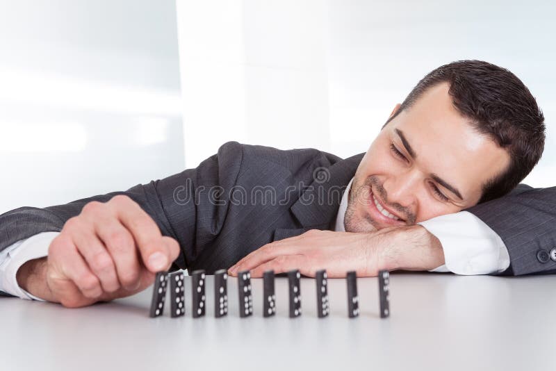 Successful businessman playing domino at the office. Successful businessman playing domino at the office