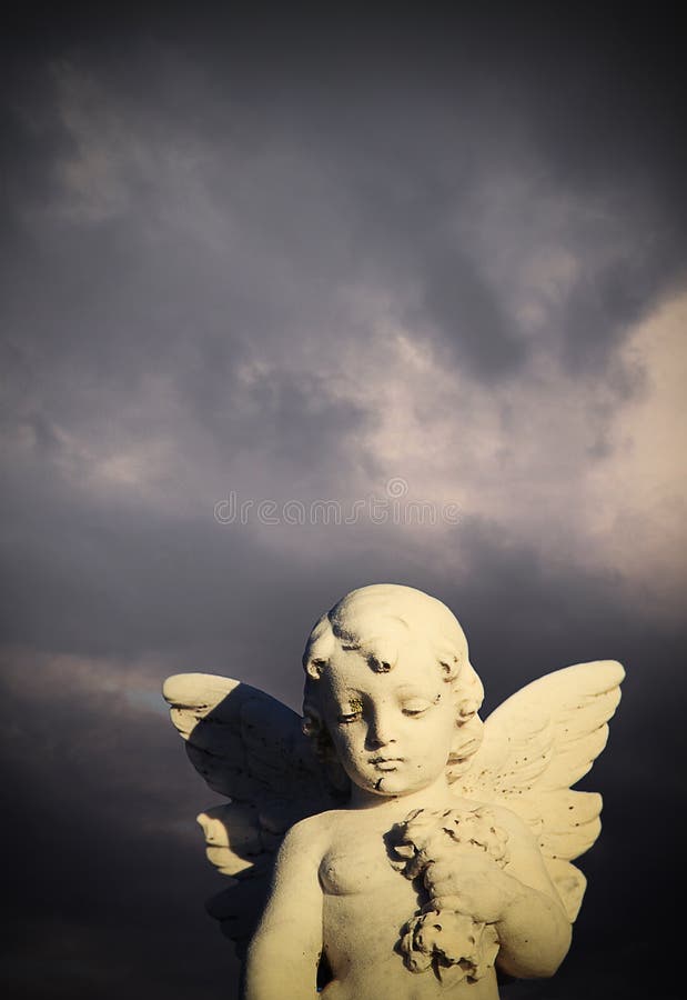 Angel statue against a stormy sky. Waverley Cemetery, Clovelly Bay, Sydney, Australia. Angel statue against a stormy sky. Waverley Cemetery, Clovelly Bay, Sydney, Australia.