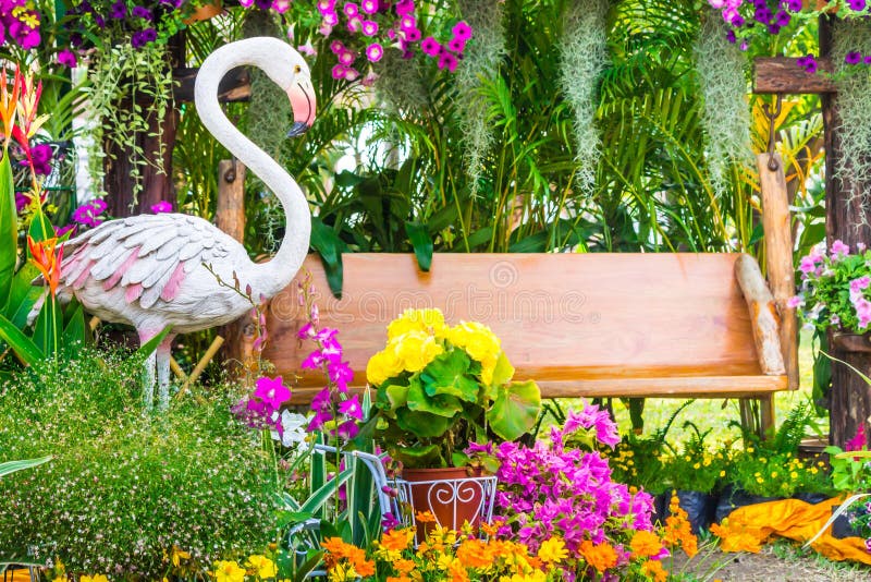 Het standbeeld van de flamingovogel in bloemtuin stock afbeeldingen