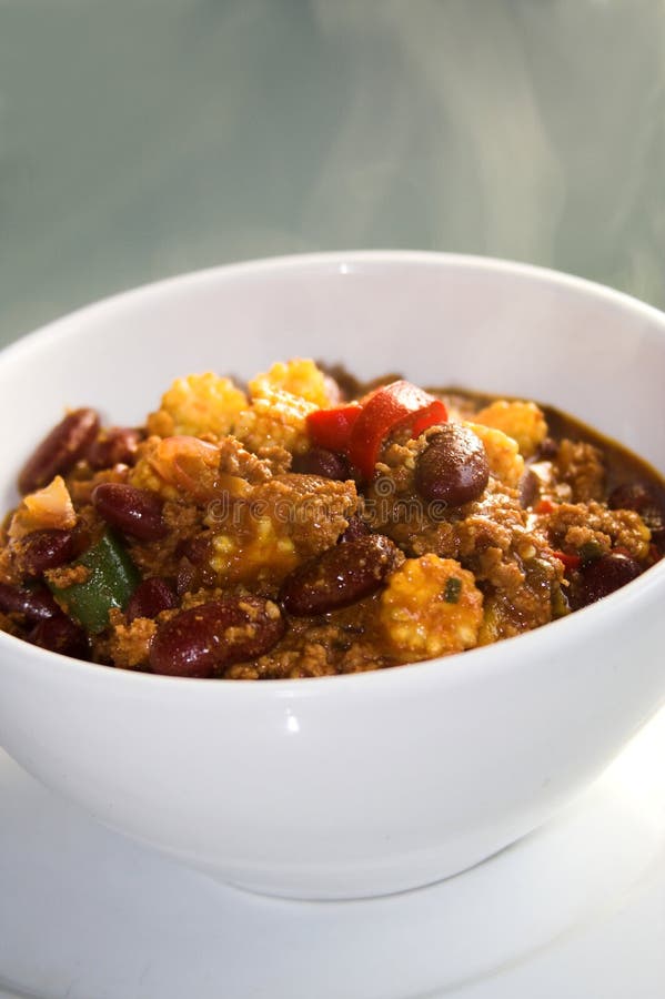 White porcelain bowl with chili con carne, plate,. White porcelain bowl with chili con carne, plate,