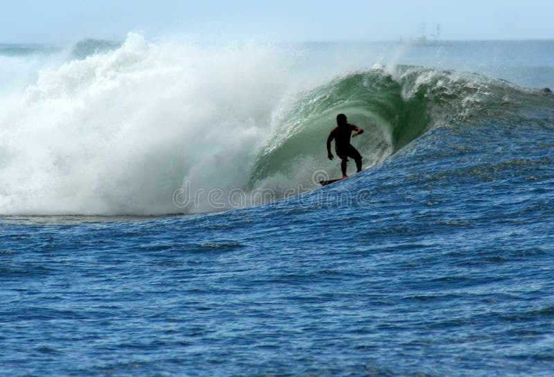 Photograph of a surfer catching a barrel in the strong waves of Bowls break on the South Shore of Oahu, Hawaii. Photograph of a surfer catching a barrel in the strong waves of Bowls break on the South Shore of Oahu, Hawaii