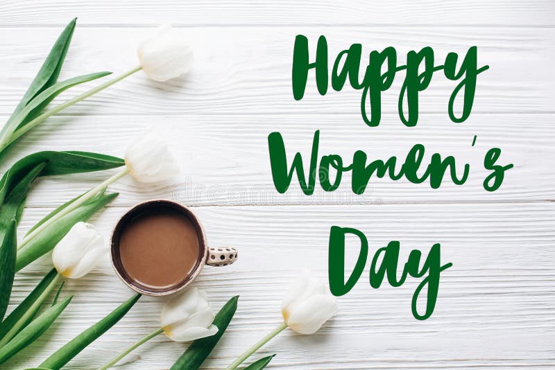 Het teken van de de dagtekst van gelukkige vrouwen op tulpen en koffie op witte houten stock fotografie Het teken van de de dagtekst van gelukkige vrouwen op tulpen en koffie op witte houten stock fotografie