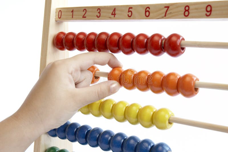 Child hand over math problem counting abacus. Child hand over math problem counting abacus