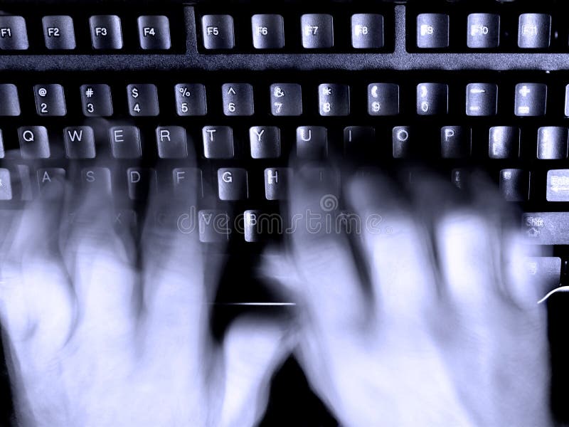 Person's blurred hands typing on a computer keyboard. Person's blurred hands typing on a computer keyboard