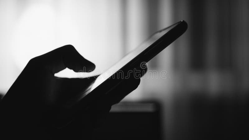Typing on phone in the evening. Shallow focus & film texture. Typing on phone in the evening. Shallow focus & film texture