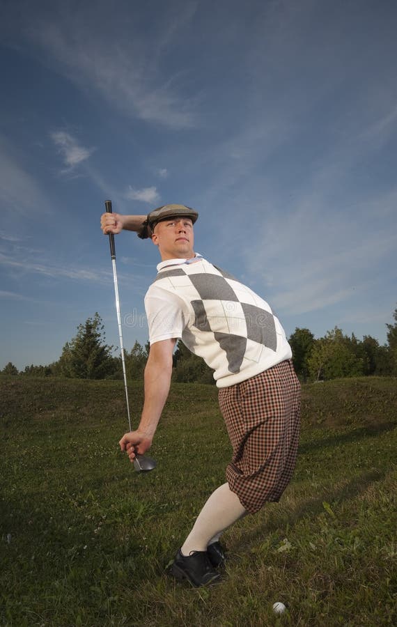 Funny looking golfer stretches before swing from the rough. Funny looking golfer stretches before swing from the rough.