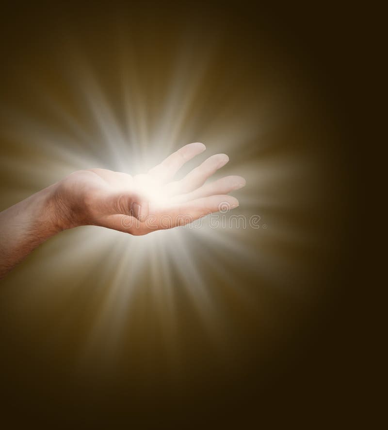 A male hand with palm open glowing with light energy on a dark warm brown background with plenty of copy space. A male hand with palm open glowing with light energy on a dark warm brown background with plenty of copy space