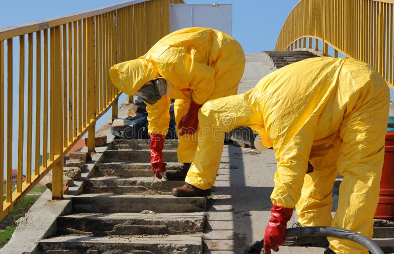 Professional people in protective uniform dealing with chemicals and dangerous materials. Professional people in protective uniform dealing with chemicals and dangerous materials