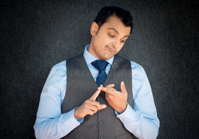 Closeup portrait, guilty, sly young guy, funny employee counting mistakes on fingers, gray black wall background. Negative human face expression. Closeup portrait, guilty, sly young guy, funny employee counting mistakes on fingers, gray black wall background. Negative human face expression