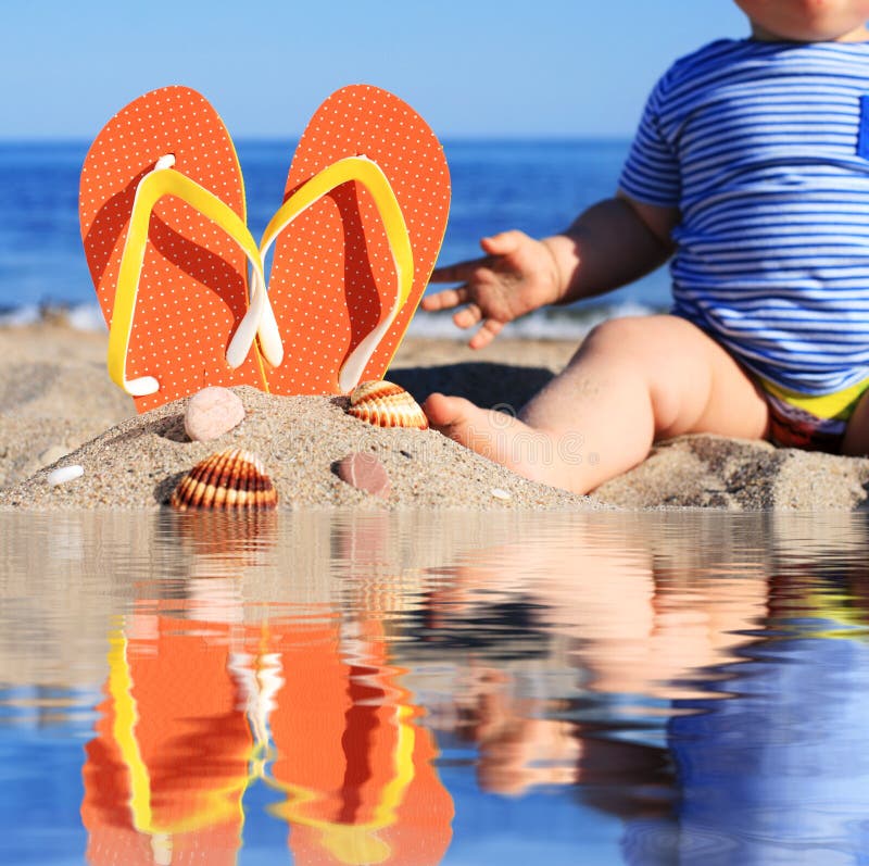 Summer time. Baby and flip-flops on the beach. Summer time. Baby and flip-flops on the beach.