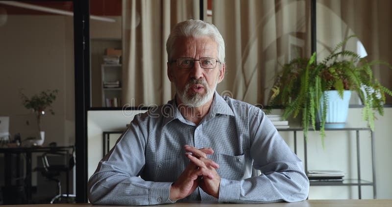 Heureux intermédiaire senior homme d'affaires tenant la conversation d'appel vidéo. banque de vidéos