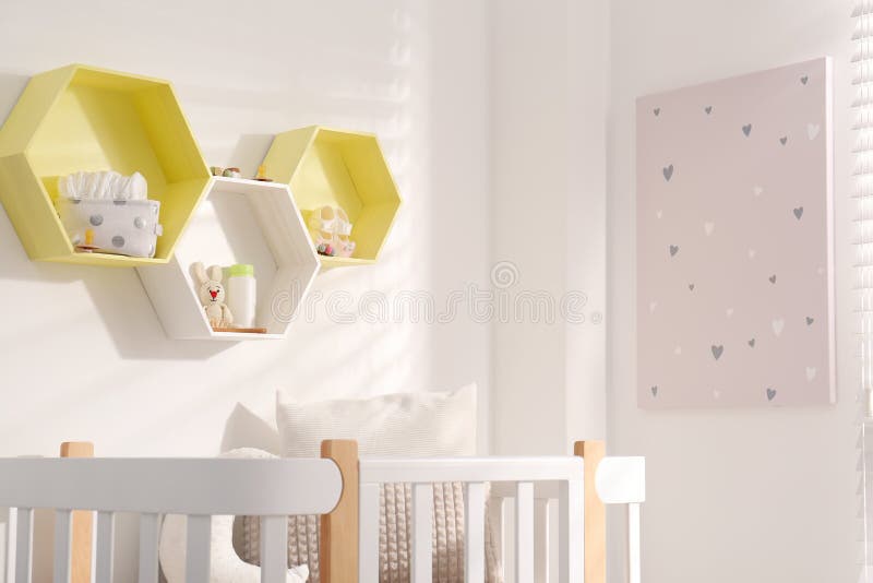 Hexagon Shaped Shelves on White Wall in Nursery. Interior Design Stock