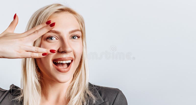 Portrait Of A Cheeky Young Hispanic Woman Pulling Silly Faces Stock 