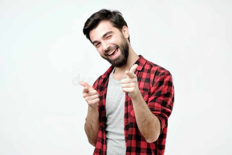 Portrait of happy hispanic man with beard pointing at you. stock image