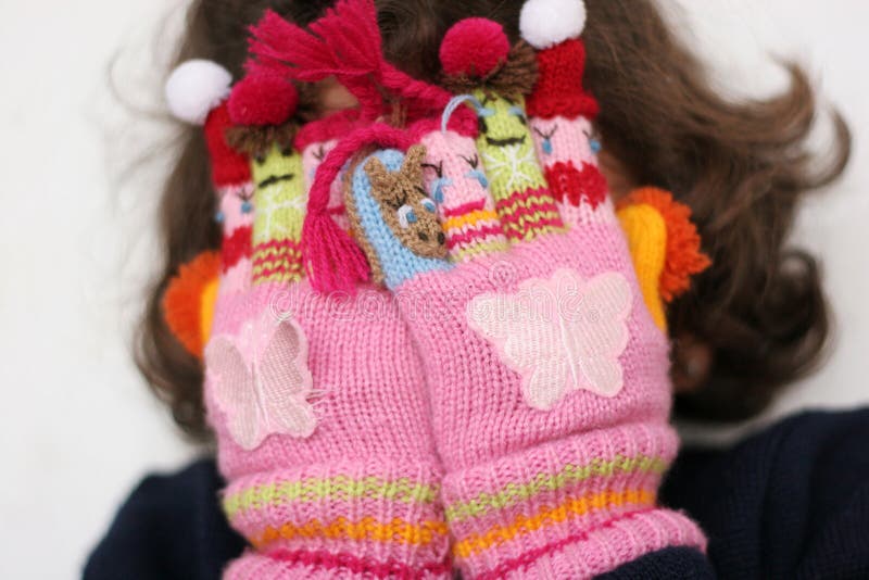 Hiding from winter stock image. Image of fingers, face 7298509