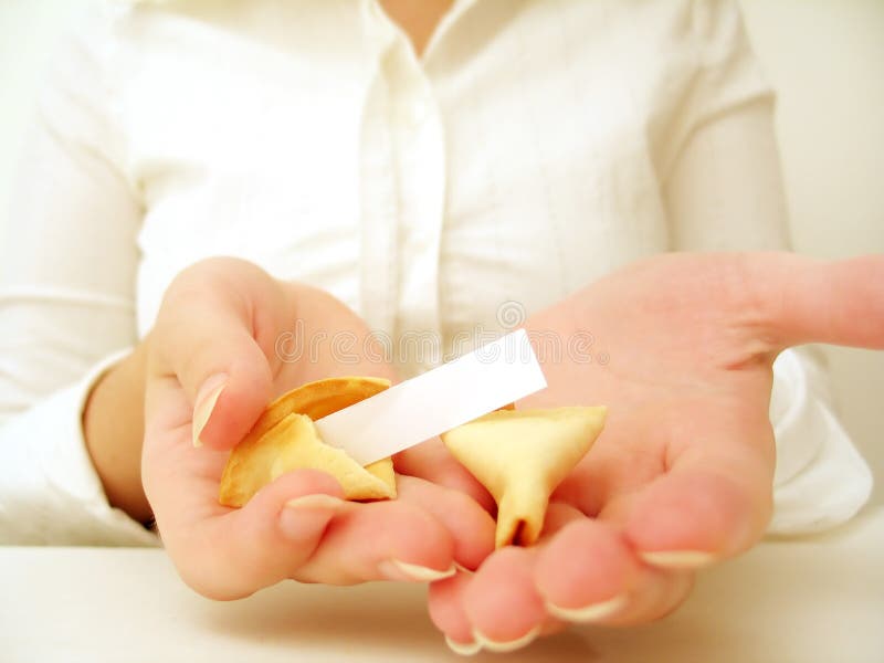 Woman holding a blank fortune and peices of the cookie in her hands. Add your own fortune. Woman holding a blank fortune and peices of the cookie in her hands. Add your own fortune.