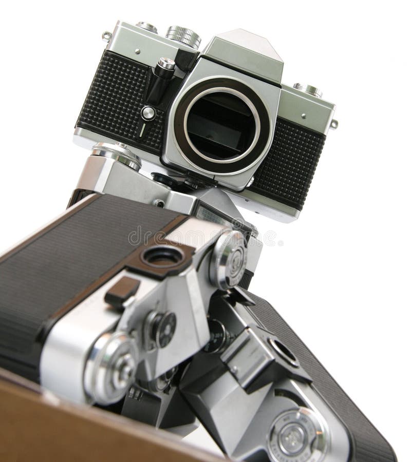 Hierarchy of old film SLR cameras. Many old russian film cameras, without lens. And at the top is professional german film camera. Isolated on white background. Old vintage film cameras stock images, royalty-free photos and pictures