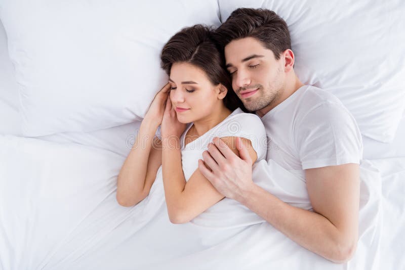 High angle above top view photo charming lady husband guy couple lying comfortable sheets bed white blanket hugging stock image