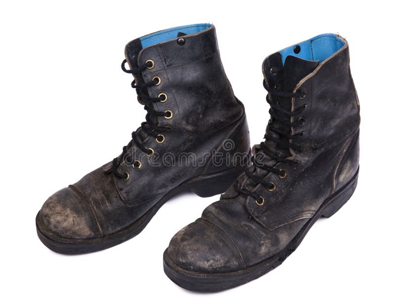 High Angle diagonal view of a very worn pair of boots, issued by the Israeli army (IDF). isolated on white background. High Angle diagonal view of a very worn pair of boots, issued by the Israeli army (IDF). isolated on white background.