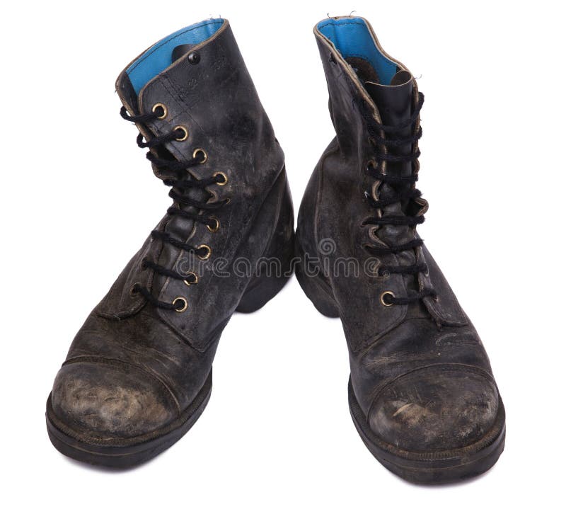 High Angle frontal view of a very worn pair of boots, issued by the Israeli army (IDF). isolated on white background. High Angle frontal view of a very worn pair of boots, issued by the Israeli army (IDF). isolated on white background.