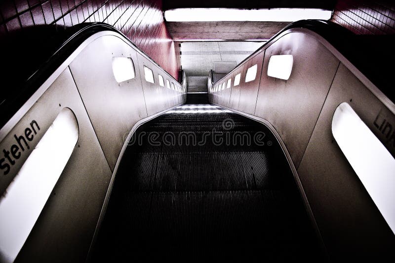 High angle shot of a black escalator with lights.