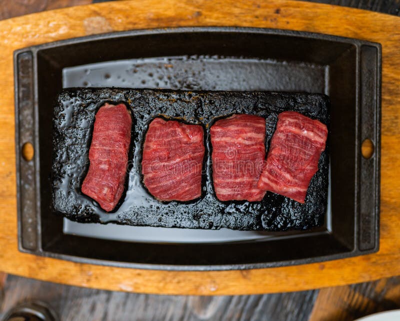High Angle Shot of Fresh Beef Meat Cooked on a Hot Stone Stock Photo
