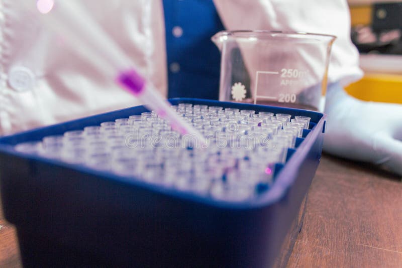 High Angle Shot of a Laboratory Assistant Adding Purple Liquid in Test